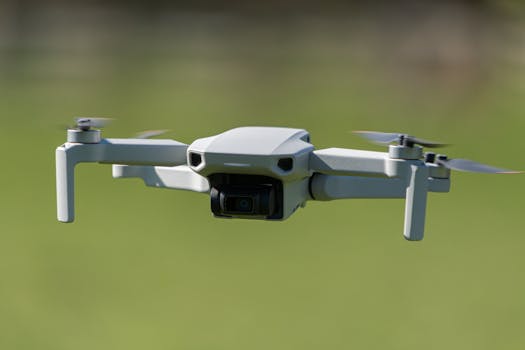 Aerial drone captured mid-flight over a lush green field in Leeds, UK.
