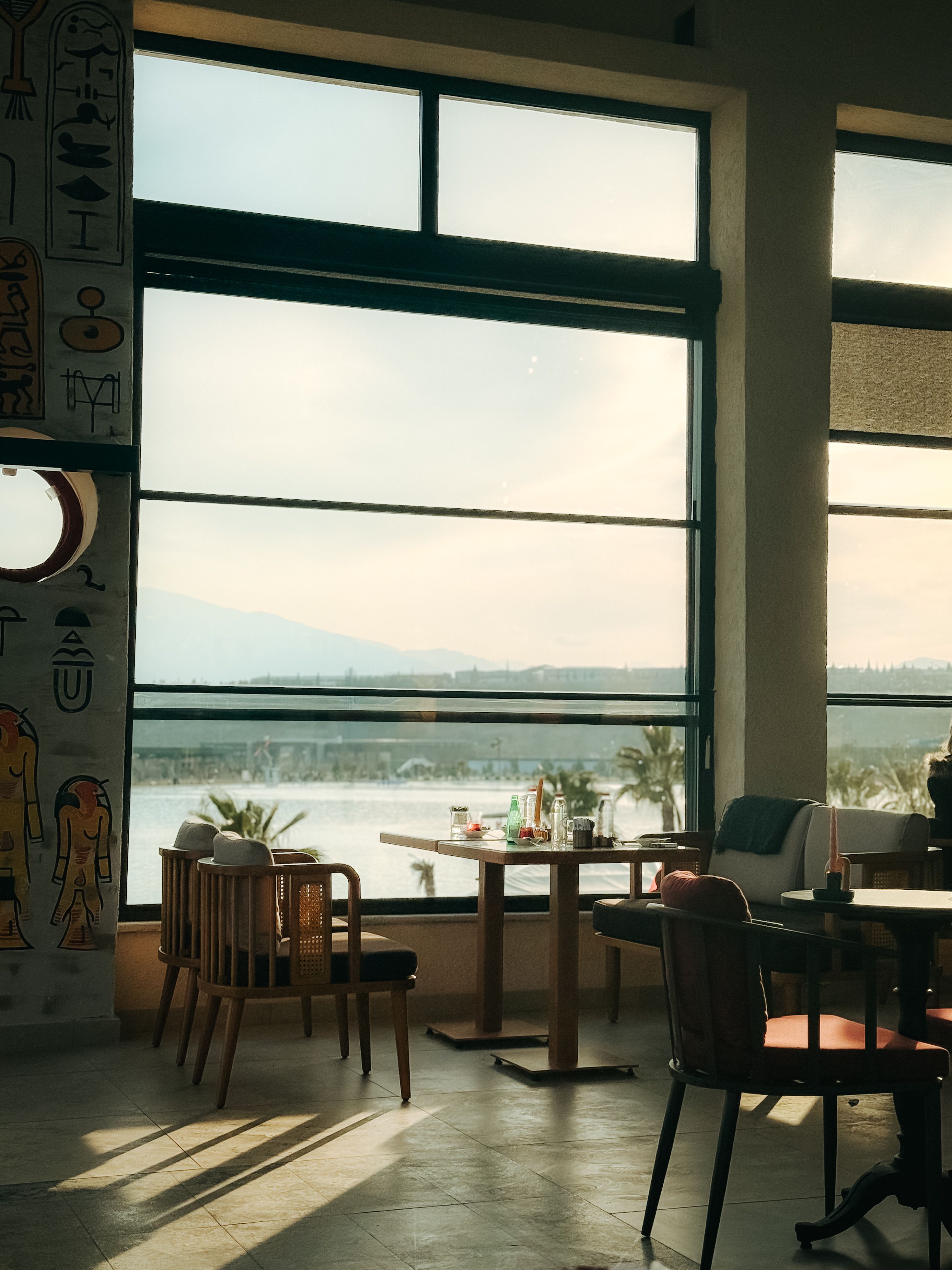 Cozy Café Interior with Scenic Window View · Free Stock Photo