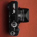 Top View of a Modern Camera on Leather Surface