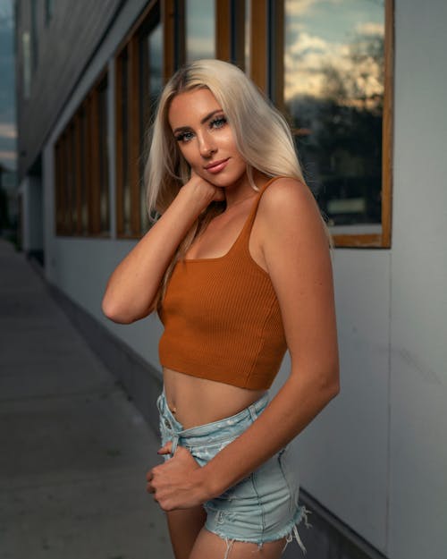 Photo of Woman in Brown Crop Top and Denim Shorts Posing