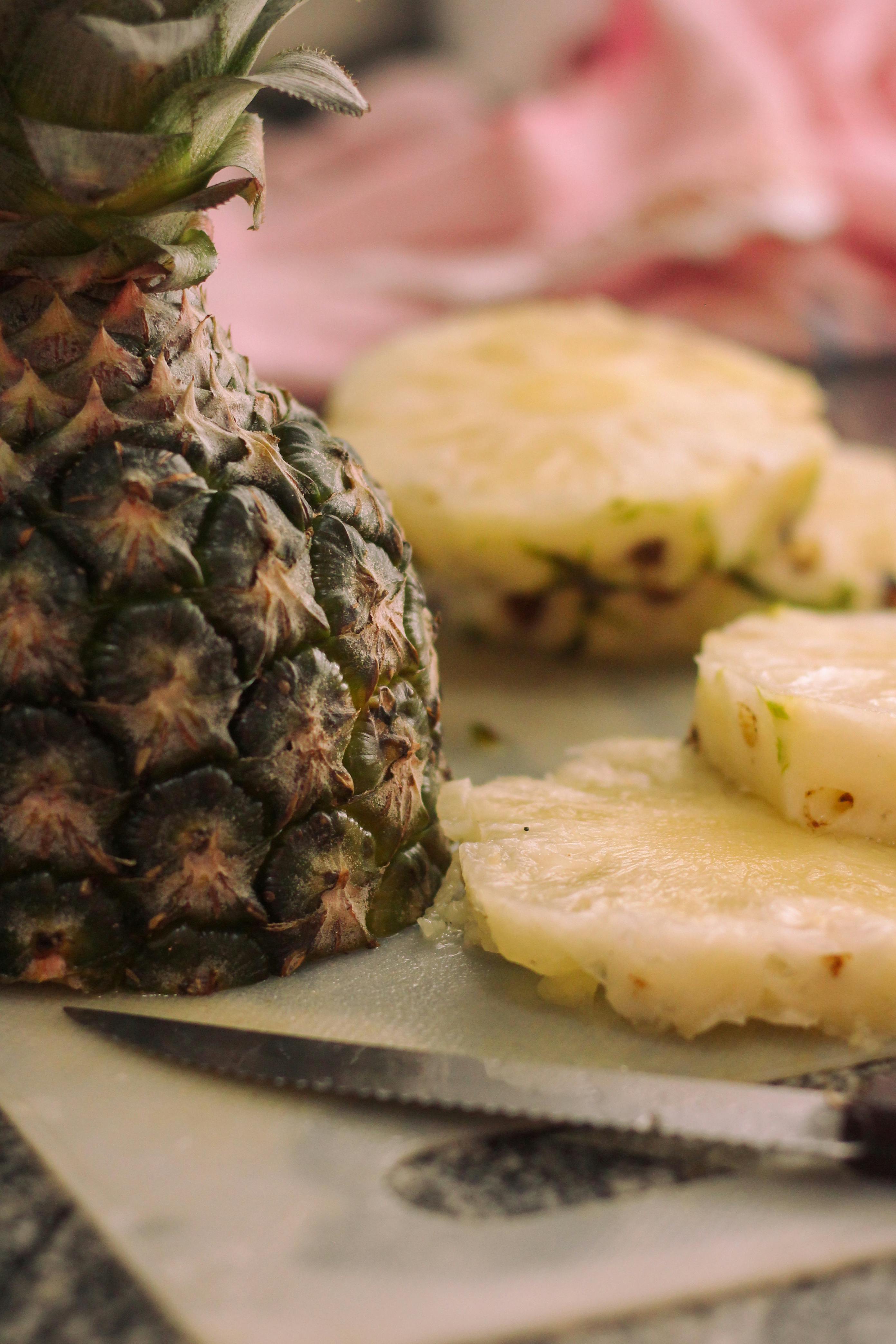 freshly sliced pineapple on cutting board