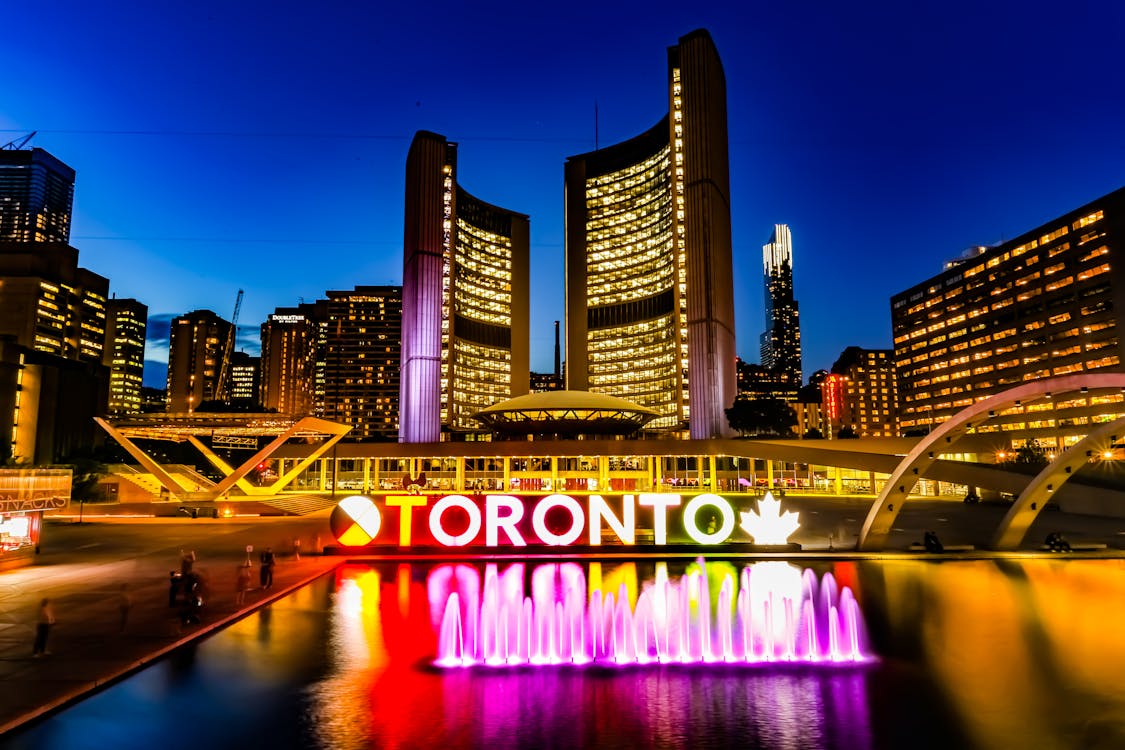 Powered-on Toronto Neon Sign Near Water Fountain