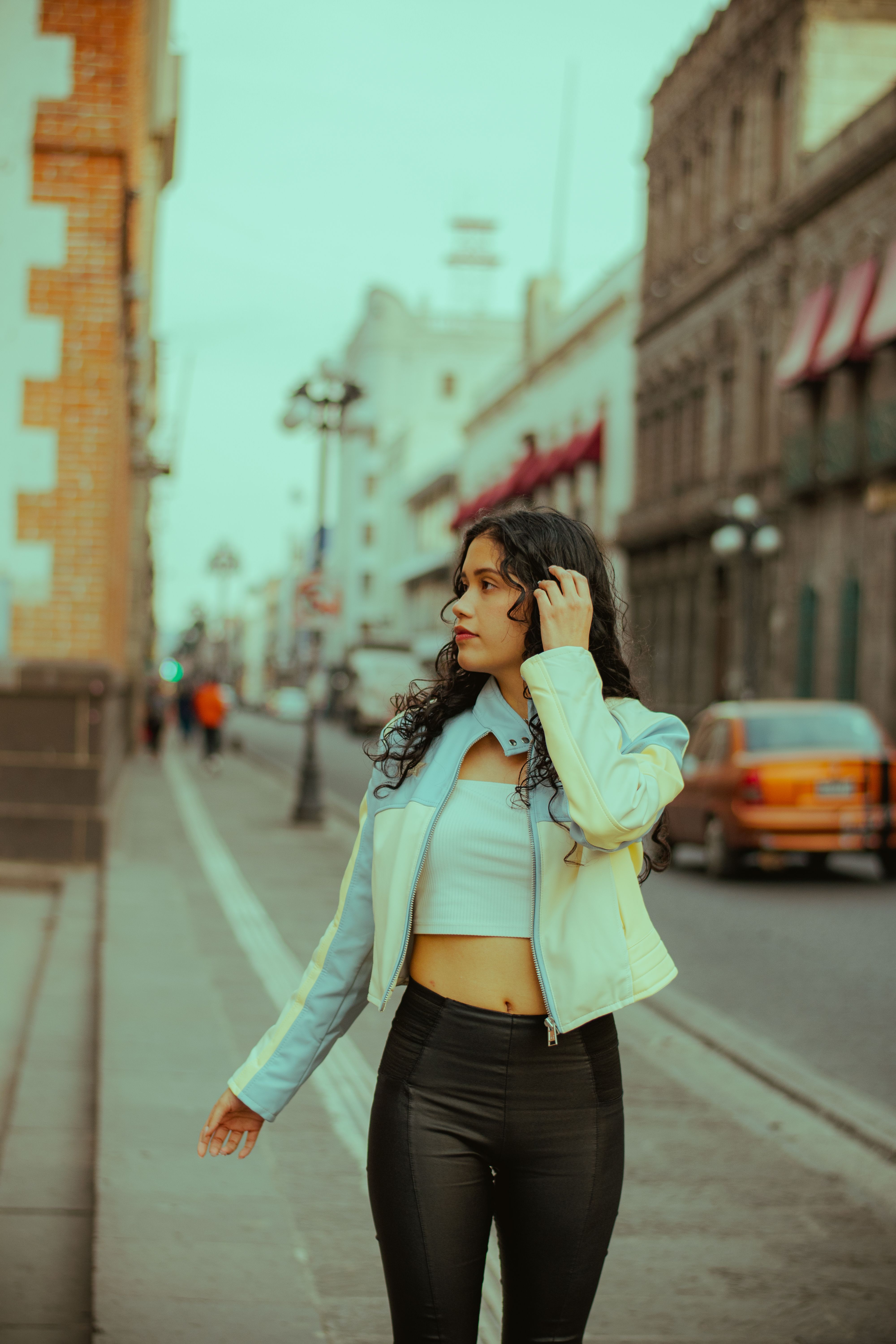 Young Woman Walking on Historic Urban Street · Free Stock Photo