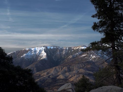 Free A scenic view of snow-covered mountains with rugged landscape and blue sky. Stock Photo