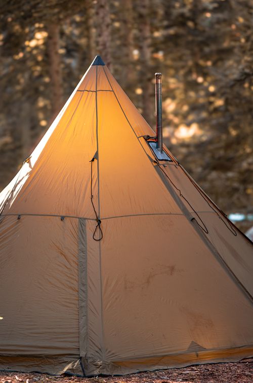 Free A warm illuminated tent set up in a serene autumn forest in Bolu, Türkiye. Stock Photo