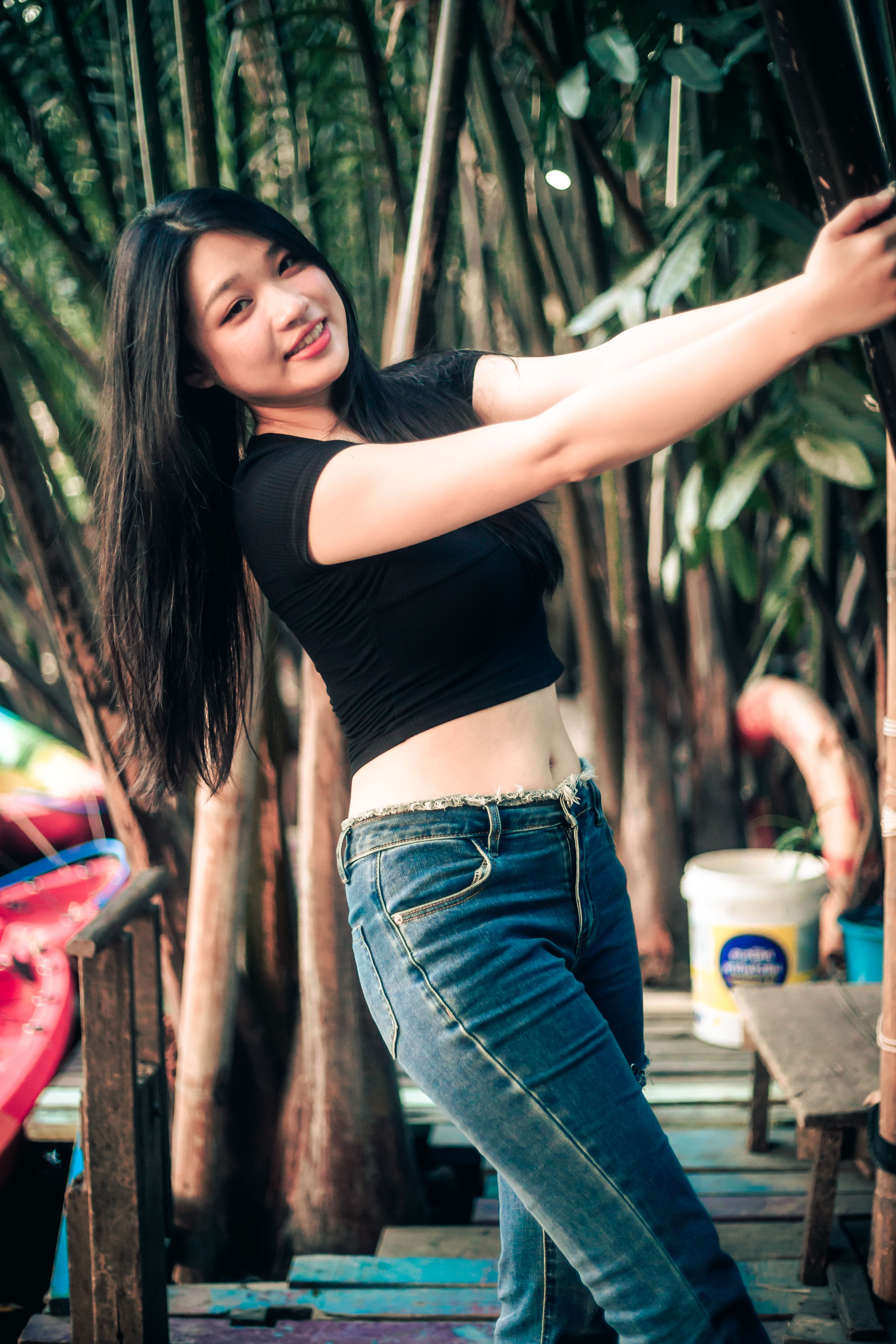 Smiling Woman Posing in a Tropical Setting · Free Stock Photo
