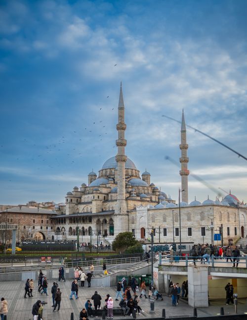 Free Capture of the New Mosque in Istanbul, showcasing Ottoman architecture and bustling city life. Stock Photo