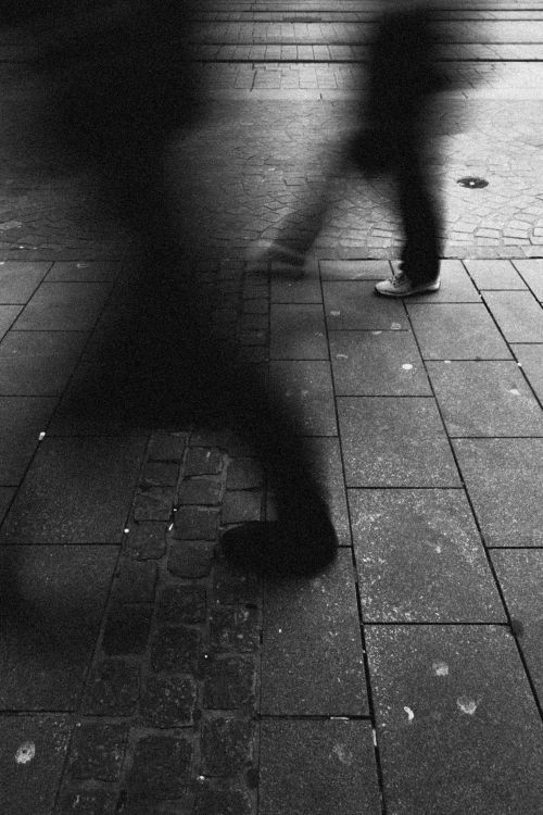 Free Black and white artistic capture of blurred pedestrians in motion on urban pavement. Stock Photo