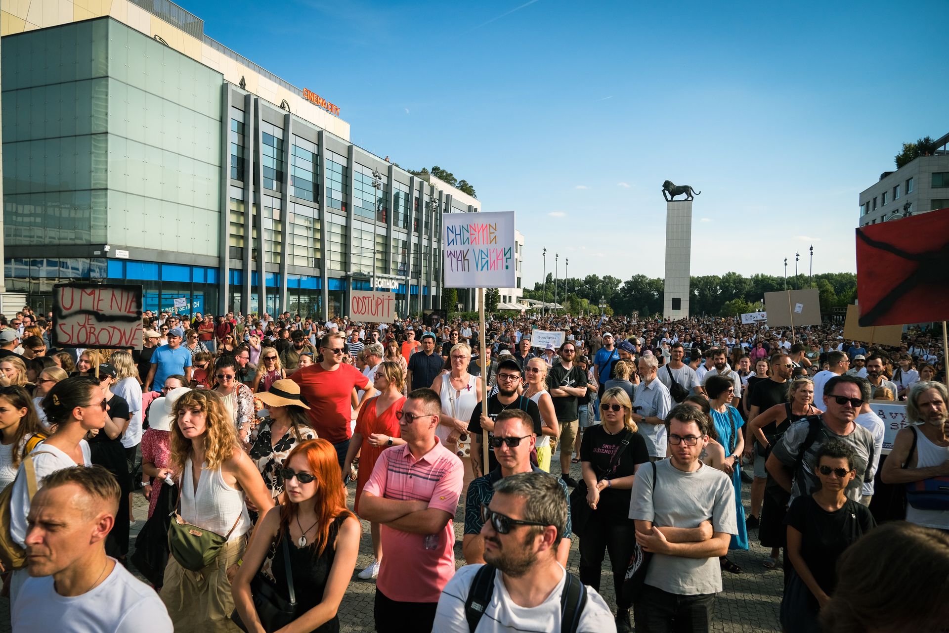 A vibrant street protest in Bratislava showcasing a large gathering of peaceful demonstrators.