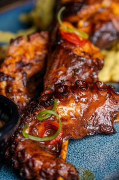 Delicious grilled octopus served on a blue plate with fresh garnish.