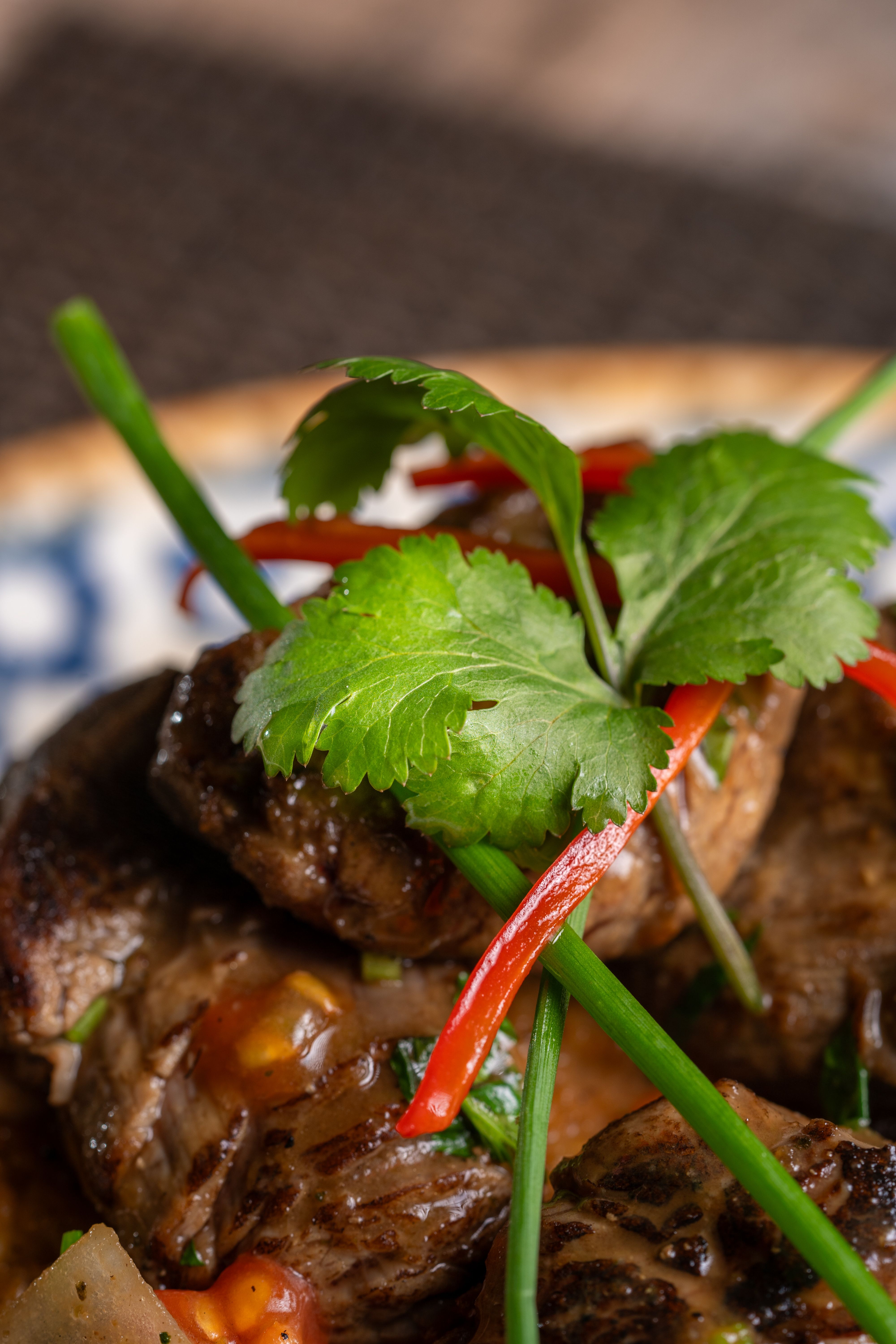 Gourmet Beef Dish with Cilantro Garnish · Free Stock Photo