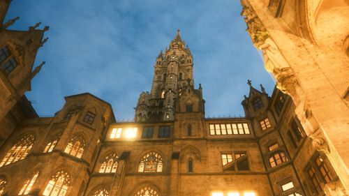 Free Low angle view of a historic Gothic building illuminated at dusk, showcasing intricate architecture. Stock Photo
