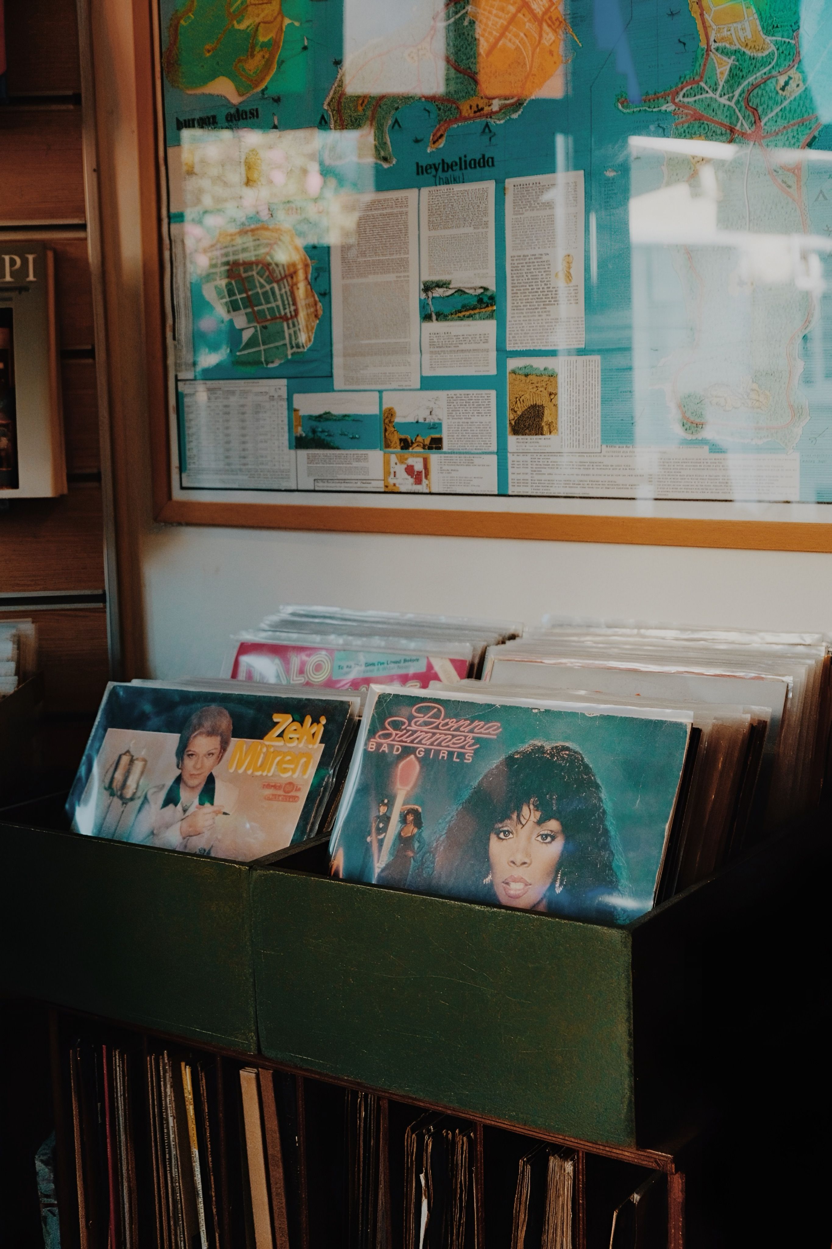 Retro vinyl records on display with vintage map in background, capturing nostalgia.