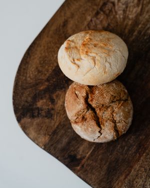Rustic artisan bread loaves on a wooden board — photo by Anh Nguyen on Pexels