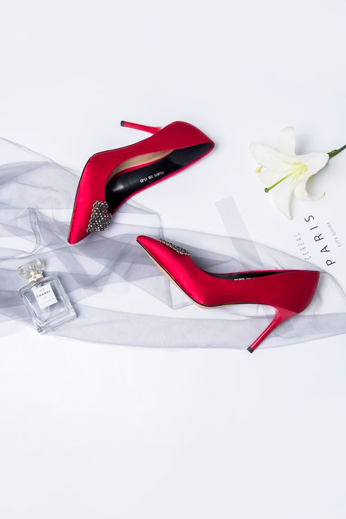 Free Stylish red high heels with perfume bottle and white lily, perfect for fashion themes. Stock Photo