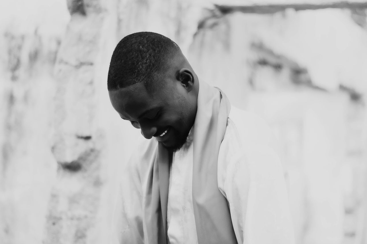 elegant black and white portrait of a smiling man with a serene expres