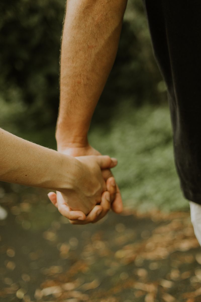 A couple holding hands outdoors