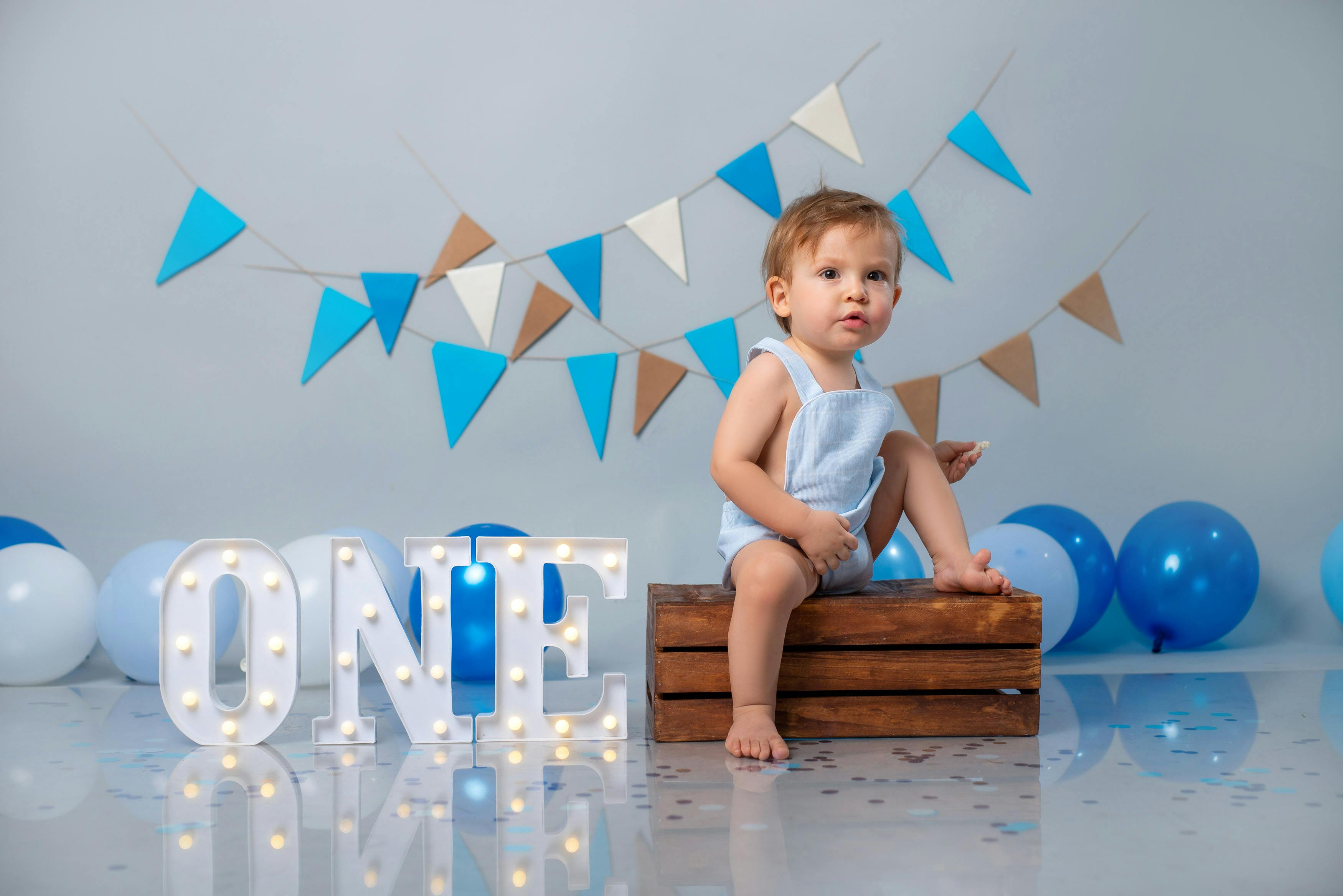 Charming first birthday scene with baby and decorations.
