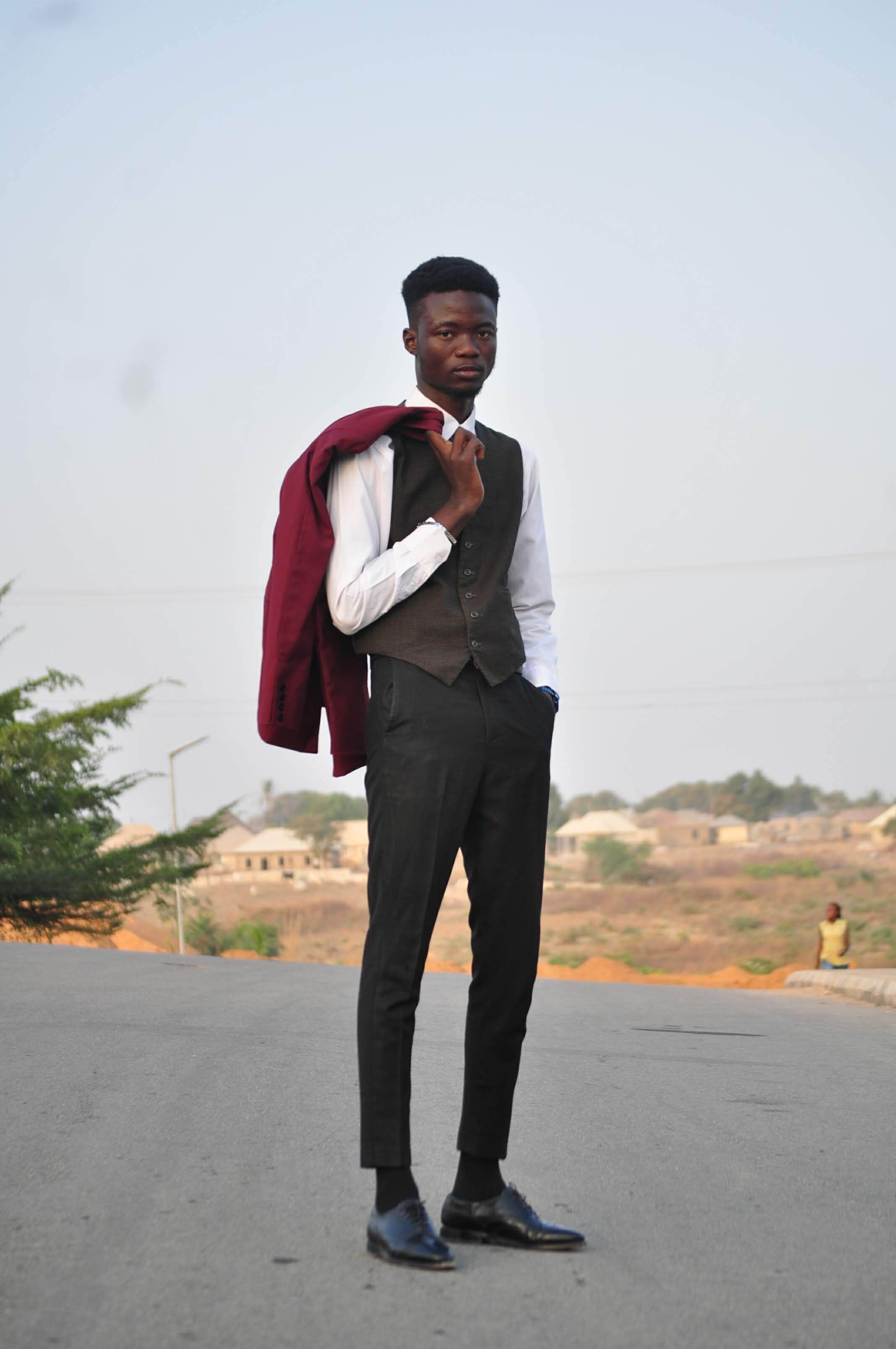 Elegant portrait of a young man with a jacket in Abuja, Nigeria.