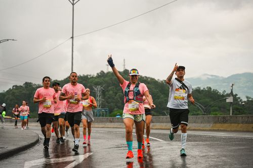 Free Vibrant marathon runners on a rainy day demonstrating teamwork and endurance outdoors. Stock Photo