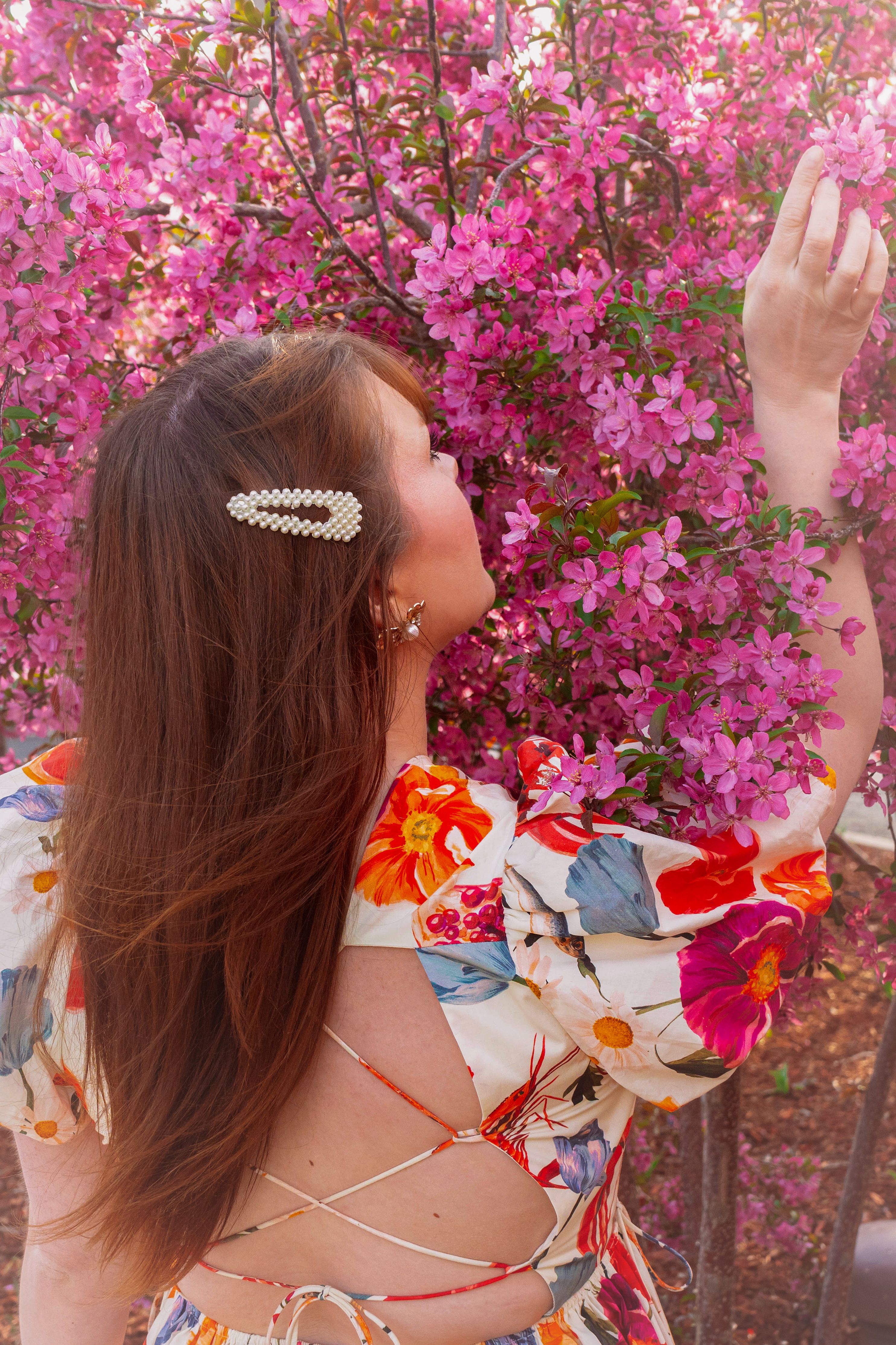 Woman Enjoying Spring Blossoms in Floral Dress · Free Stock Photo