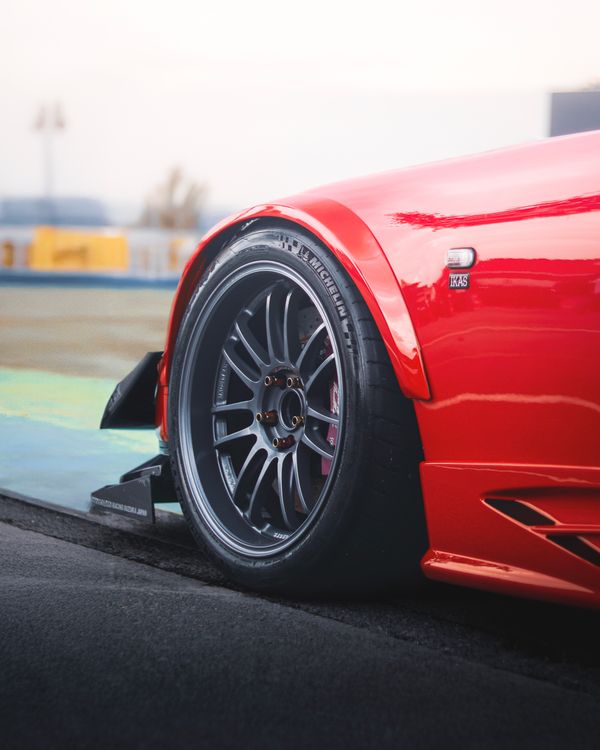 Close-Up of a Red Sports Car Wheel on Track · Free Stock Photo