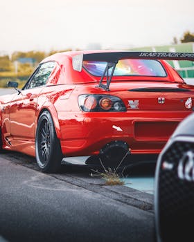 Vibrant red Honda sports car at İstanbul raceway, showcasing aerodynamic design.