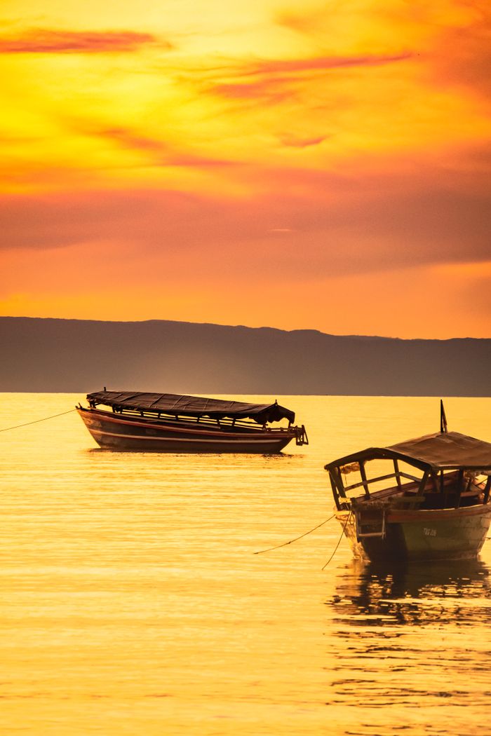 Traditional dhow sailing boat on calm water off Zanzibar