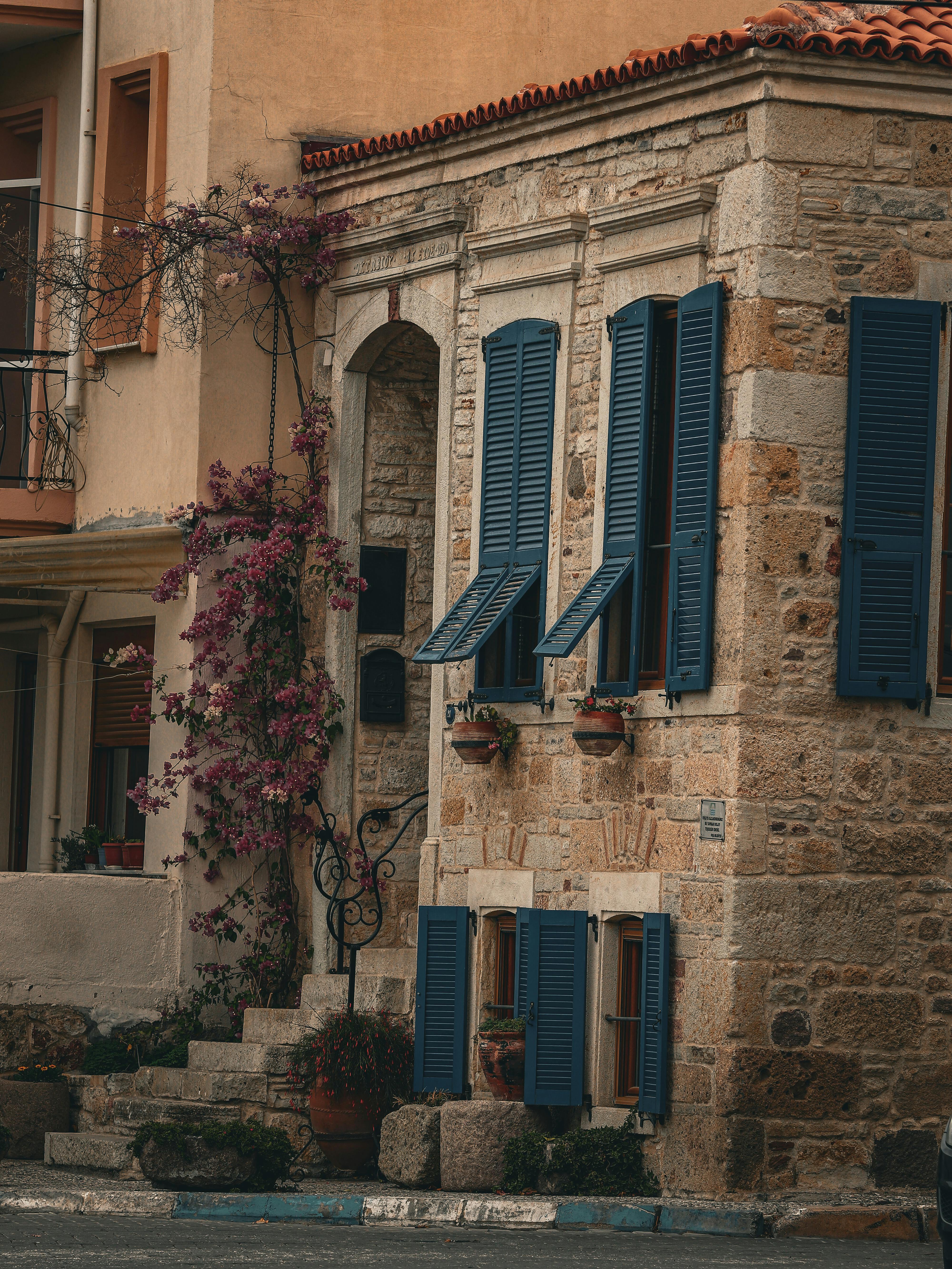 charming stone house with blue shutters in izmir