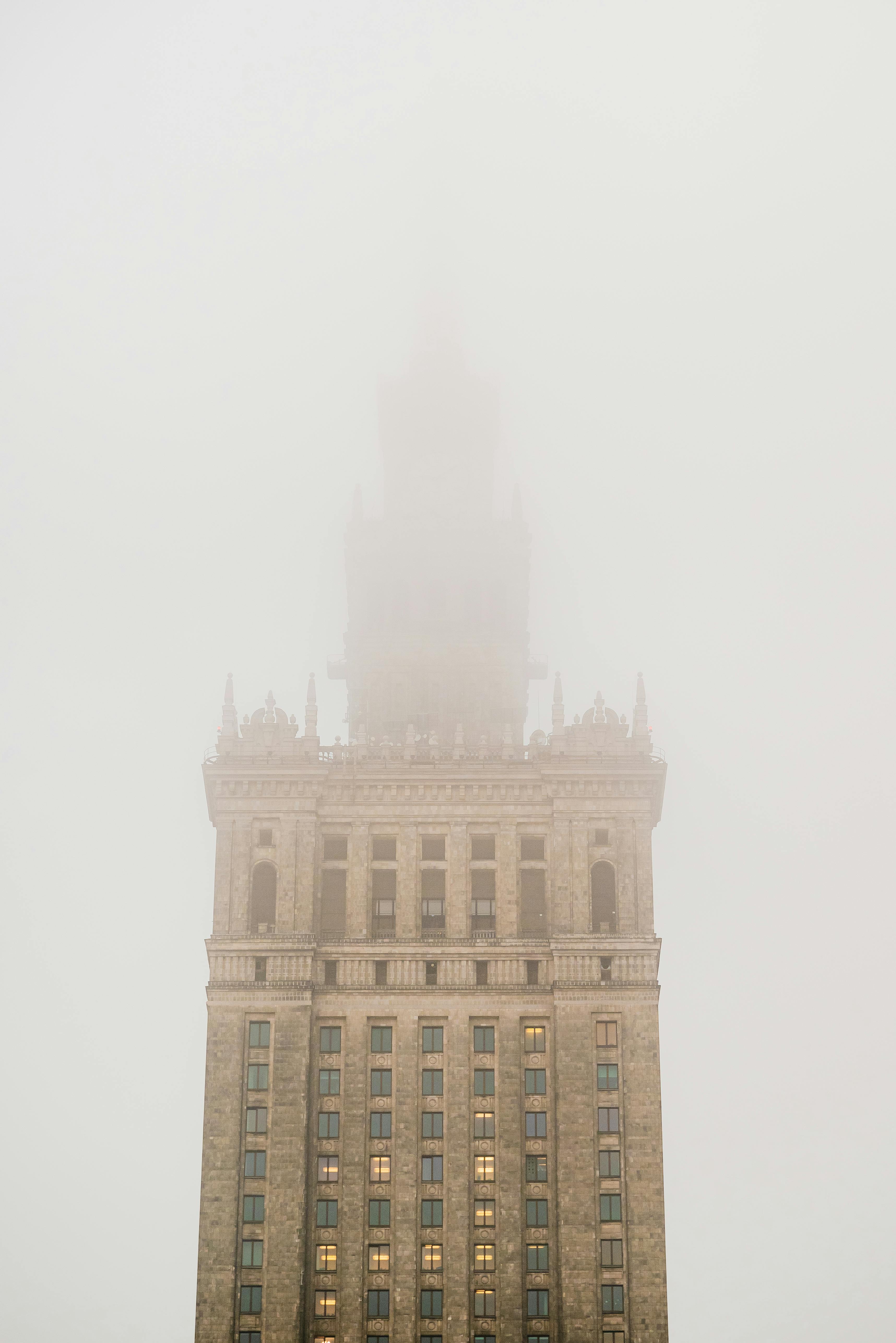 The iconic Palace of Culture and Science in Warsaw enveloped in mystical winter mist.