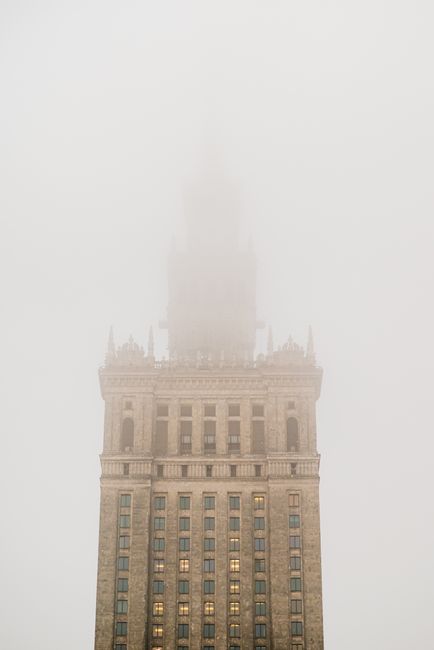 The iconic Palace of Culture and Science in Warsaw enveloped in mystical winter mist.