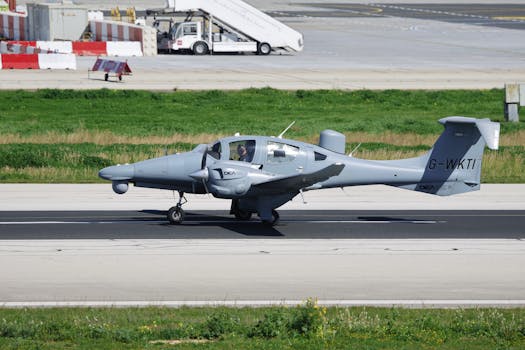 Diamond DA42 aircraft taxiing on airport runway under clear skies.