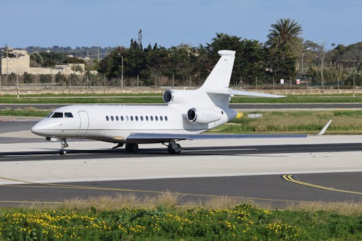 A private jet taxiing on an airport tarmac with clear skies, showcasing modern aviation.