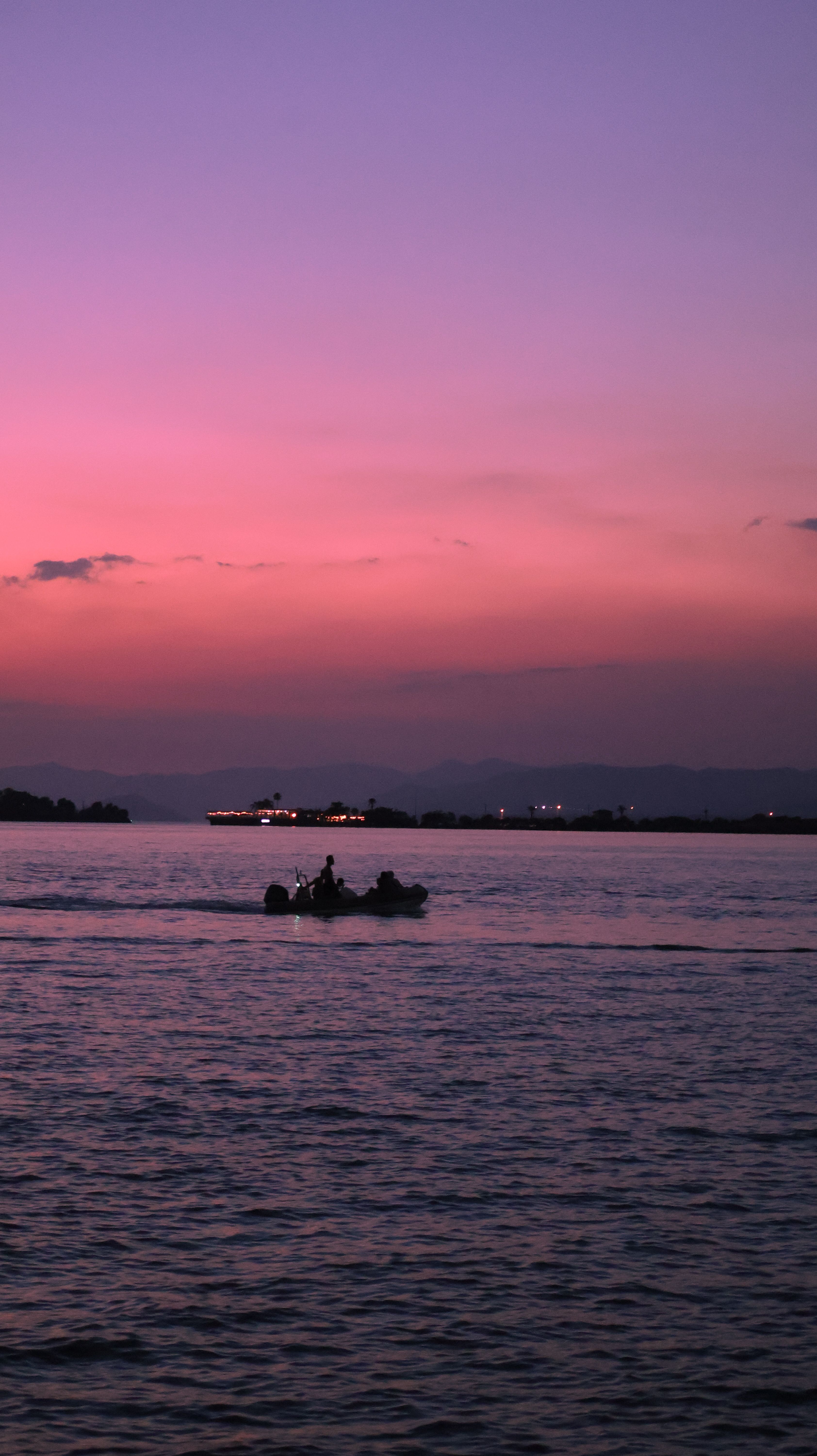 Tranquil Boat Ride at Sunset on a Calm Lake · Free Stock Photo