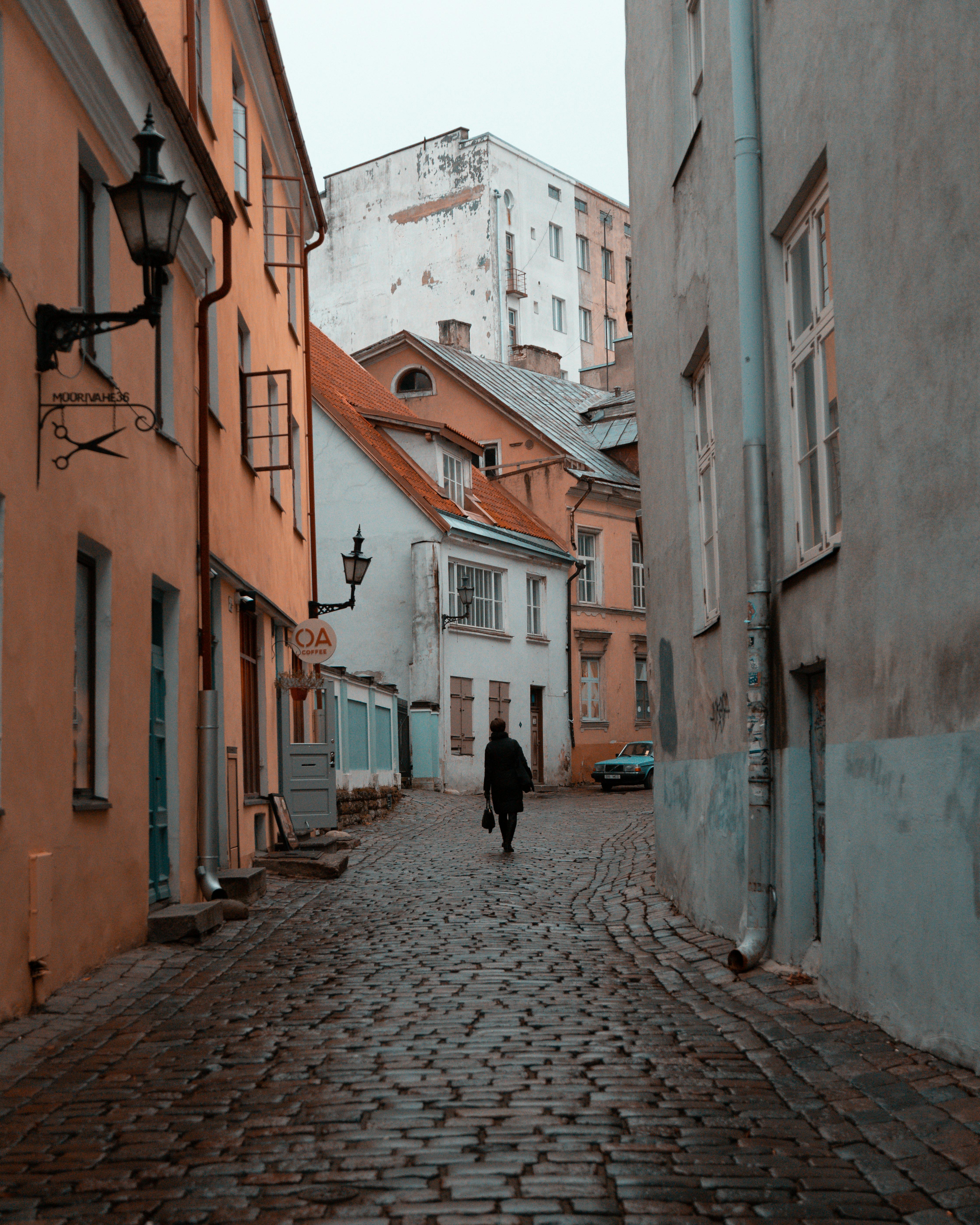 A picturesque cobblestone street in Tallinn's historic Old Town, featuring colorful buildings and a classic medieval atmosphere.