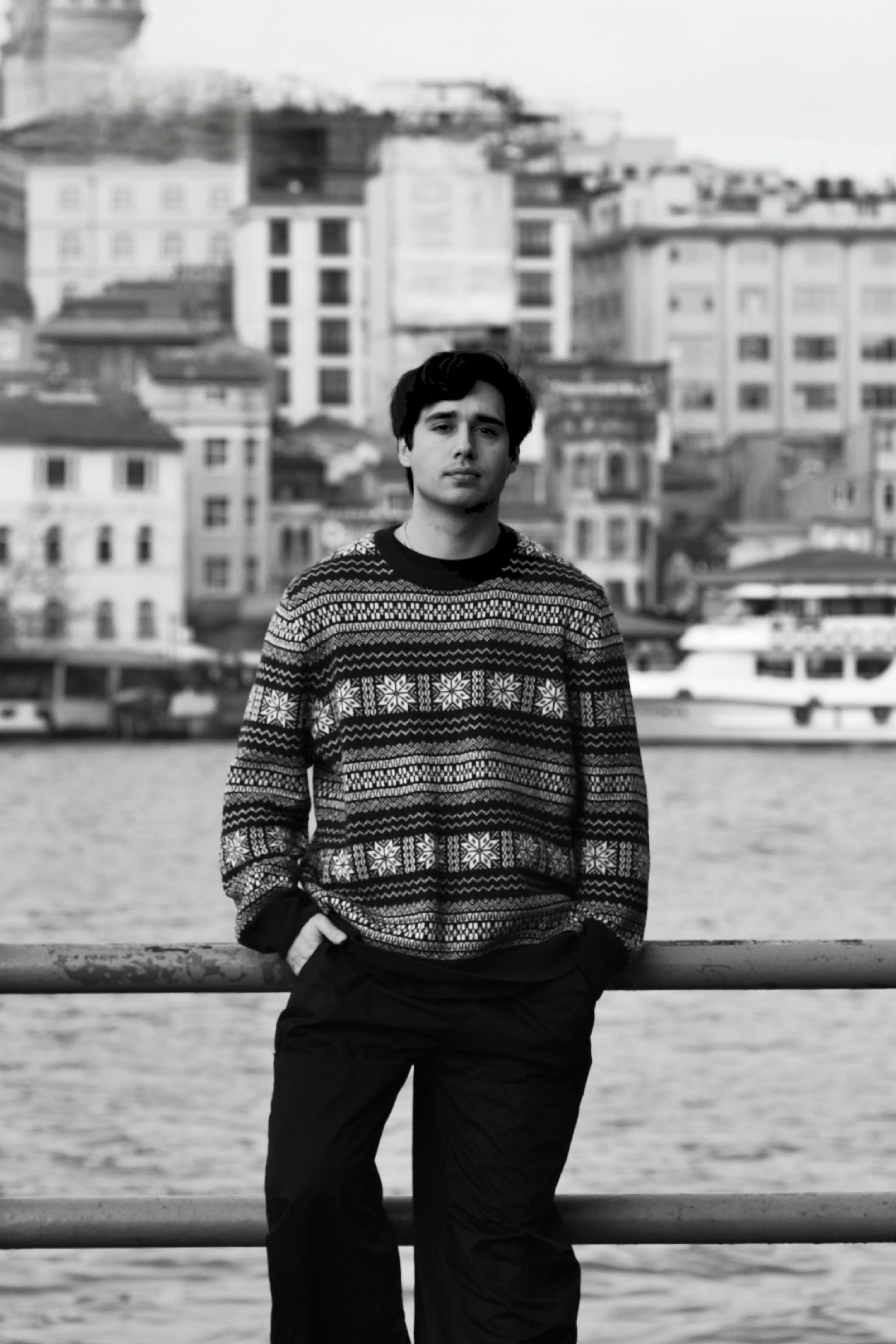Black and white portrait of a man standing by the Bosphorus in Istanbul.