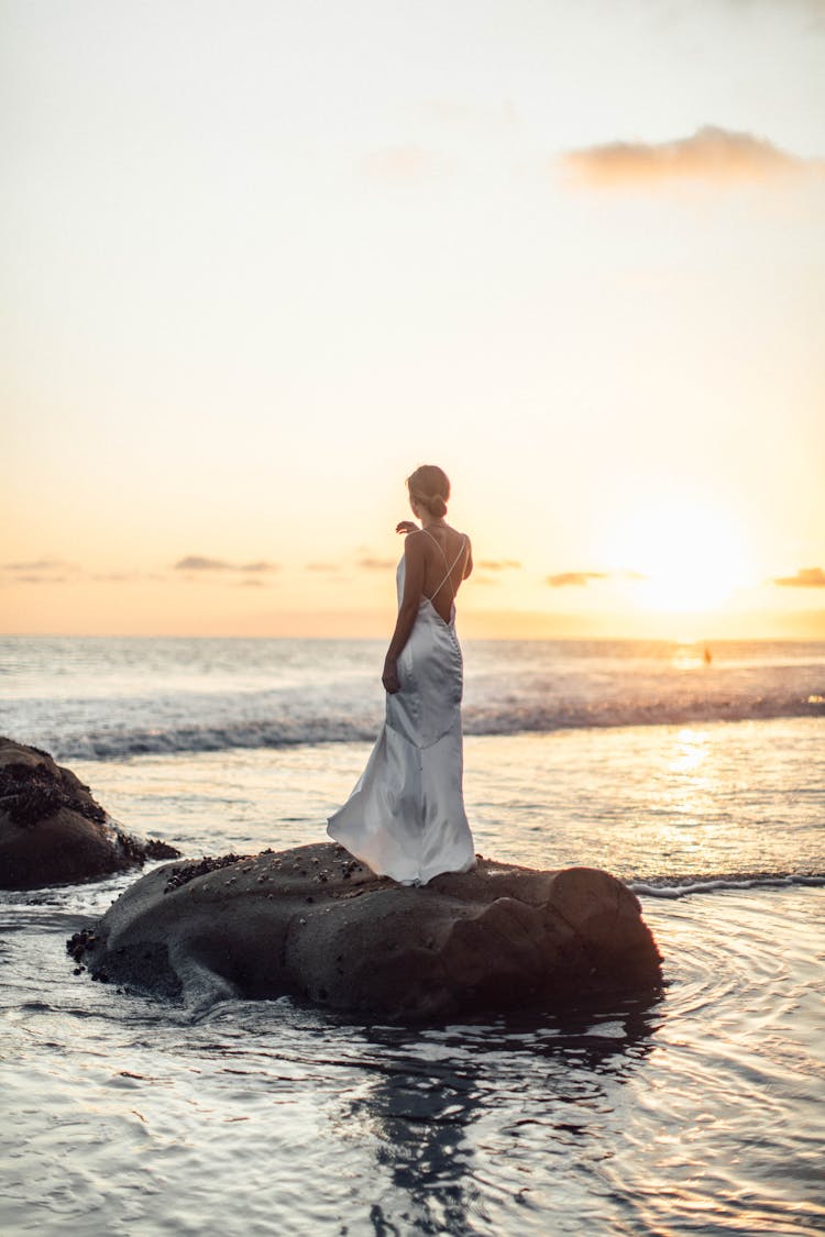 Woman Standing On Rock