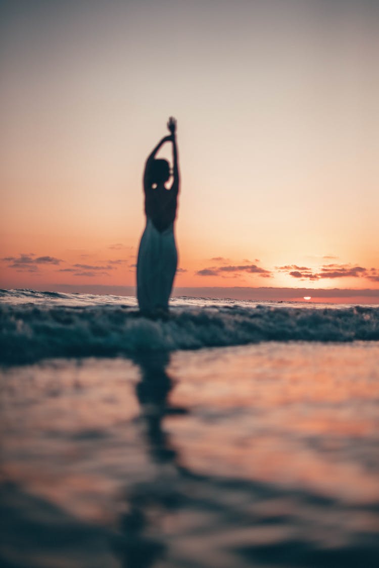 Woman Wearing White Dress Standing On Seashore