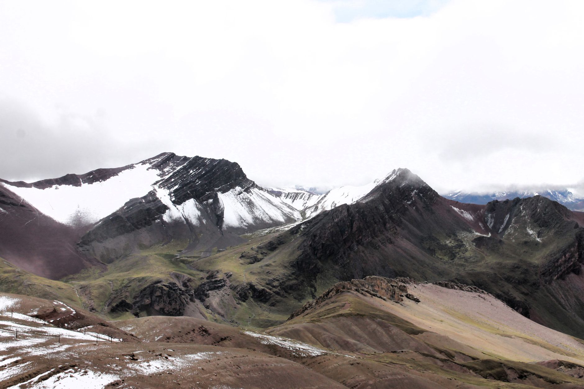 Breathtaking view of the Andes mountains with snow and lush valleys.