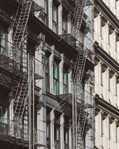 Free Close-up of New York's iconic apartment facades with classic fire escapes. Stock Photo