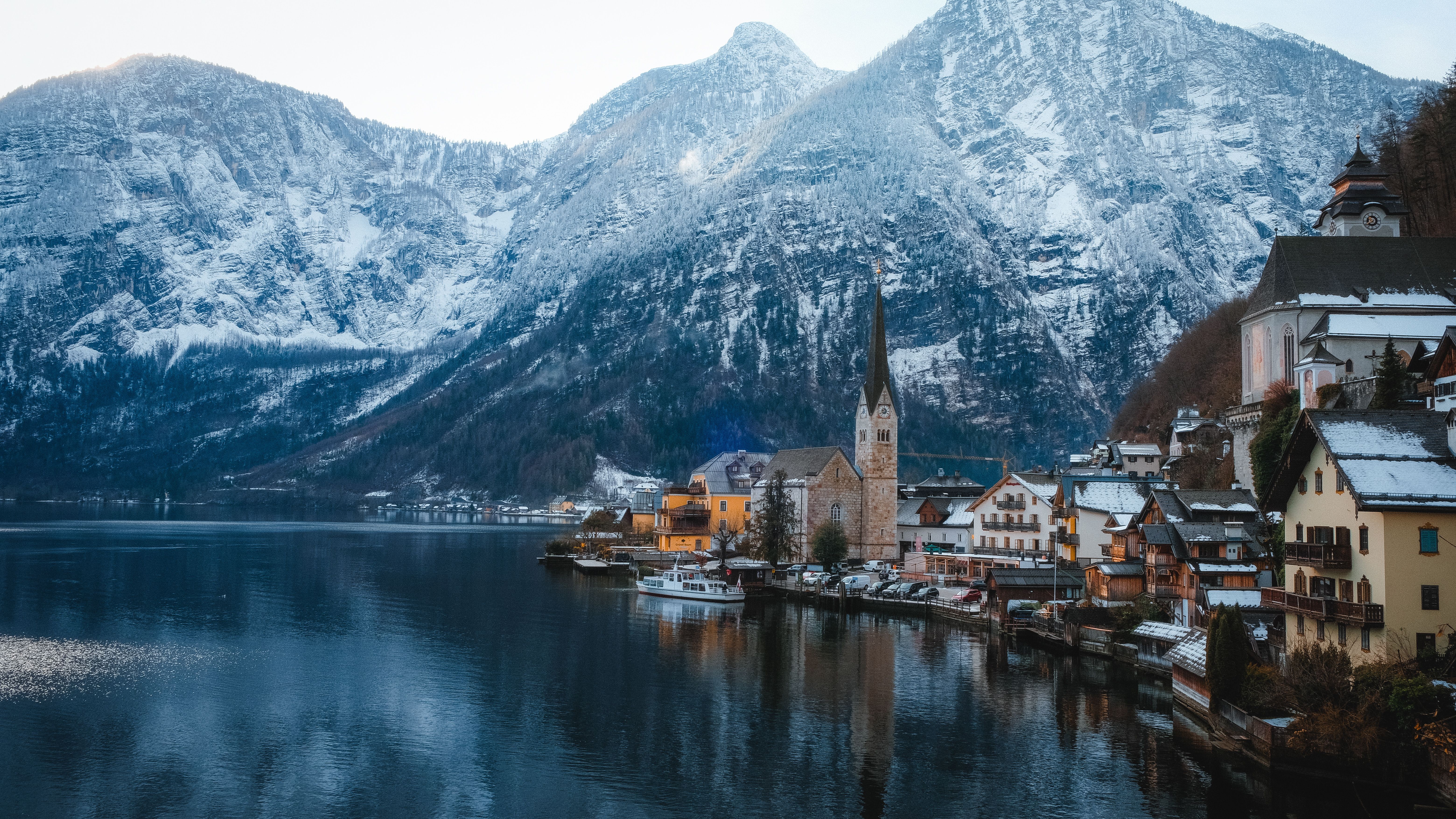 Breathtaking winter scene of Hallstatt village with snowy mountains, Austria.