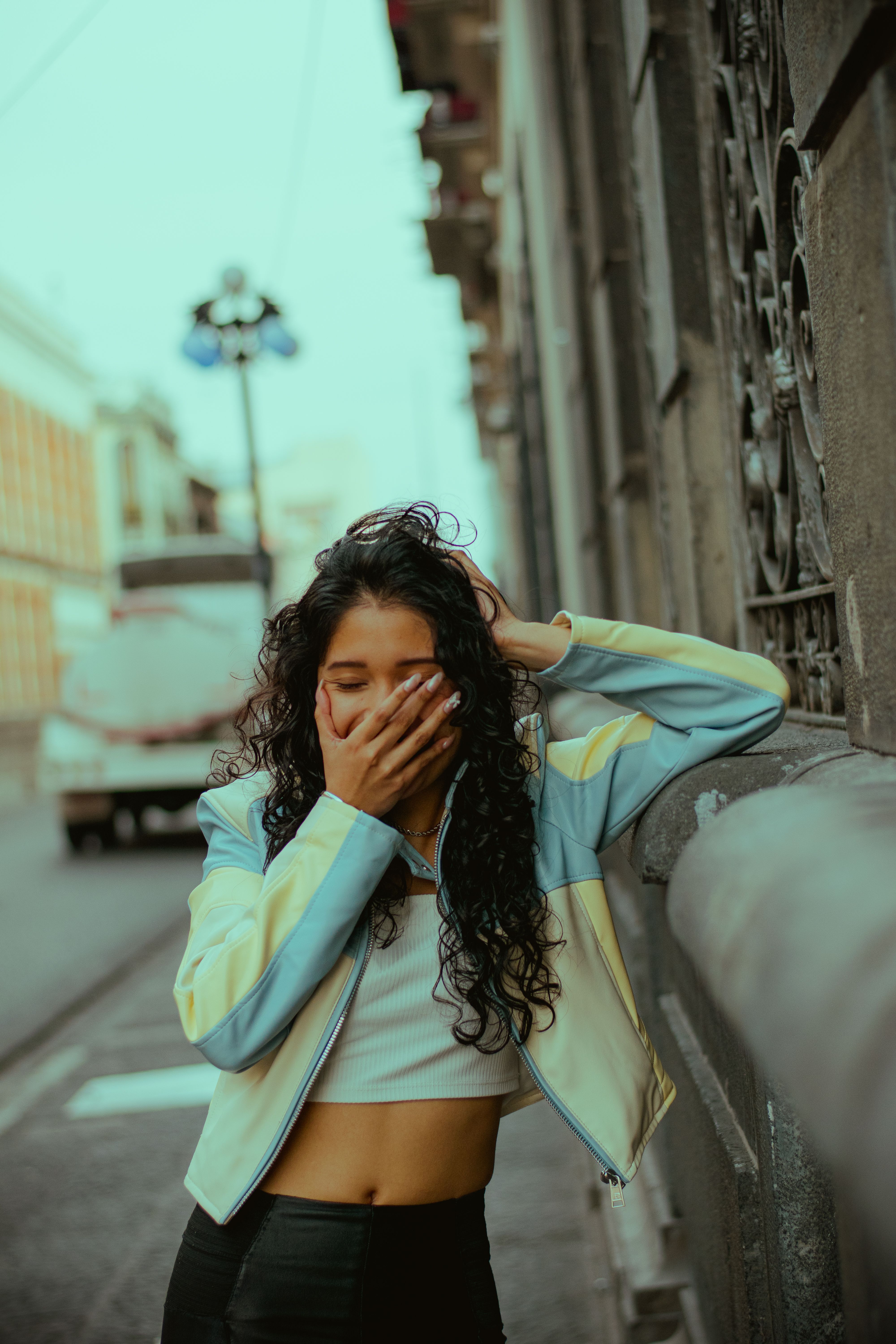 Young Woman Laughing on City Street · Free Stock Photo