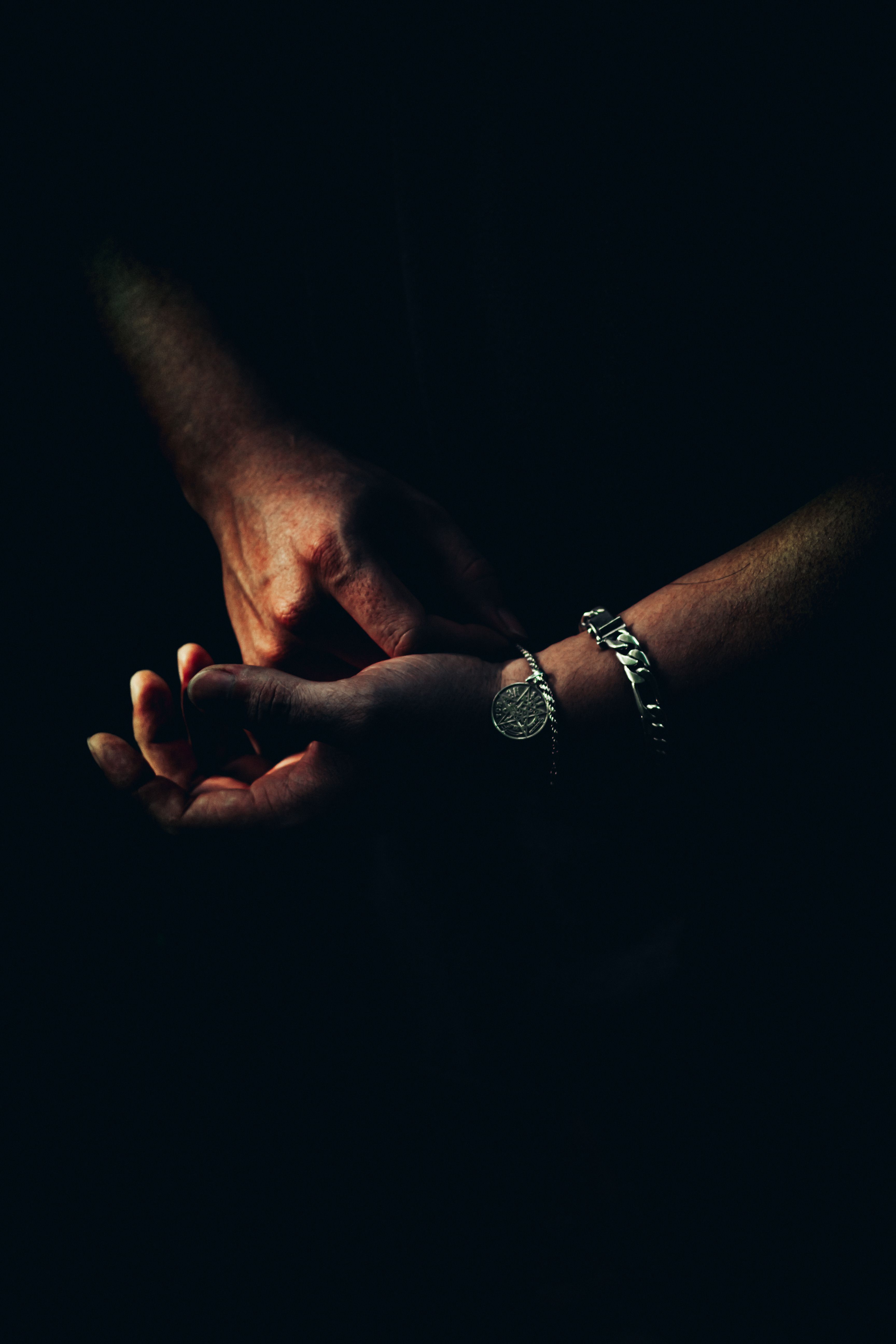 Artistic Close-Up of Hands in Dramatic Lighting · Free Stock Photo