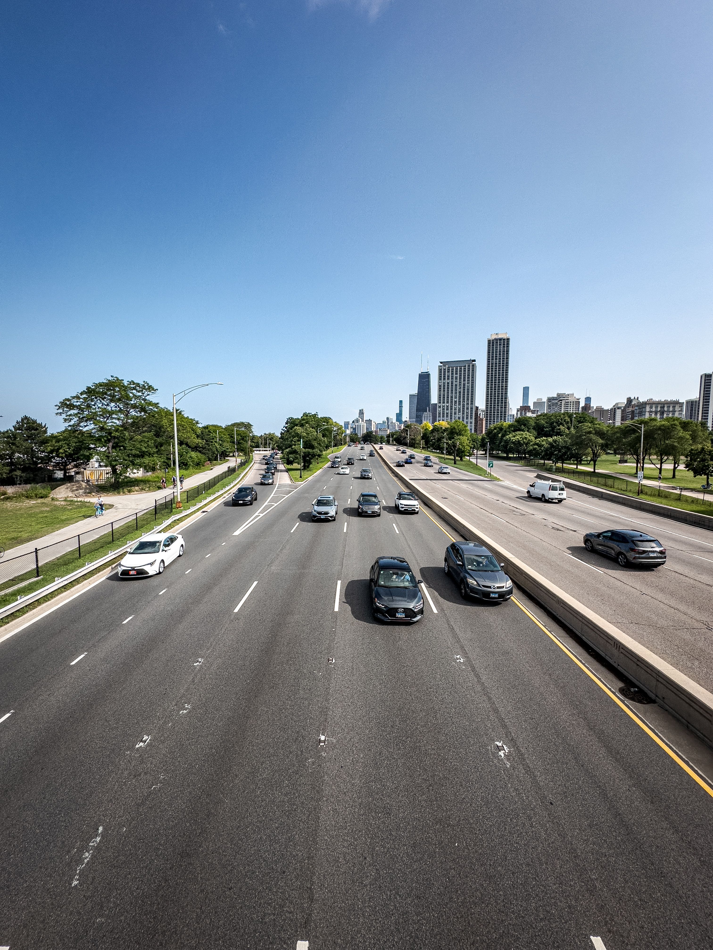 Aerial View of Urban Highway and City Skyline · Free Stock Photo