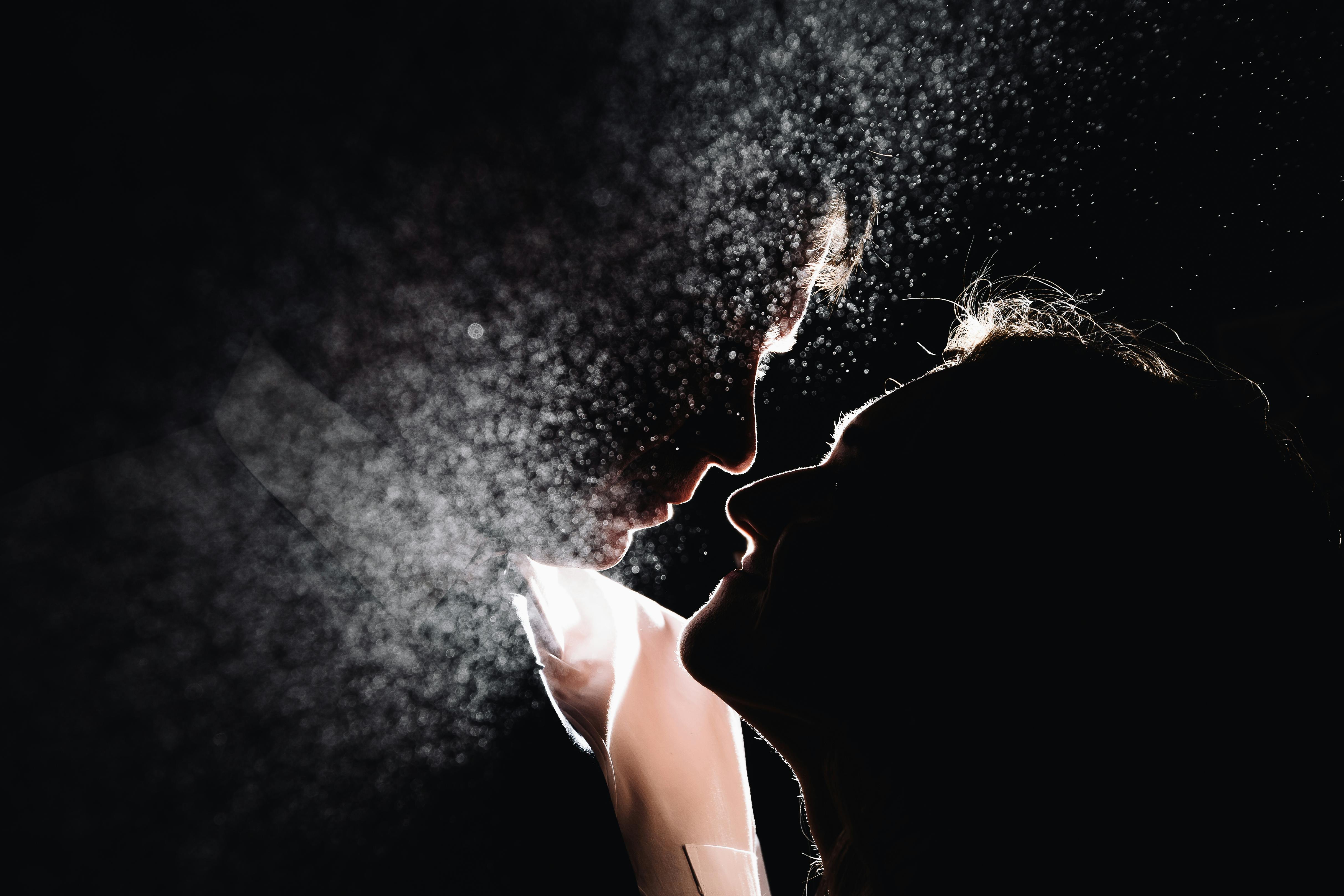 一对夫妇爱上了戏剧性的灯光和薄雾效果，他们的轮廓显得喜怒无常