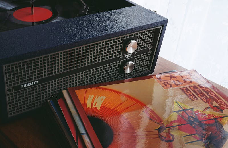Turntable playing a vinyl record in warm light