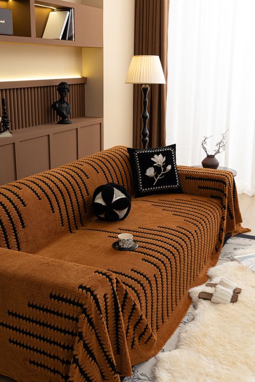 Free Elegant brown sofa cover in a warm, inviting living room setting. Stock Photo