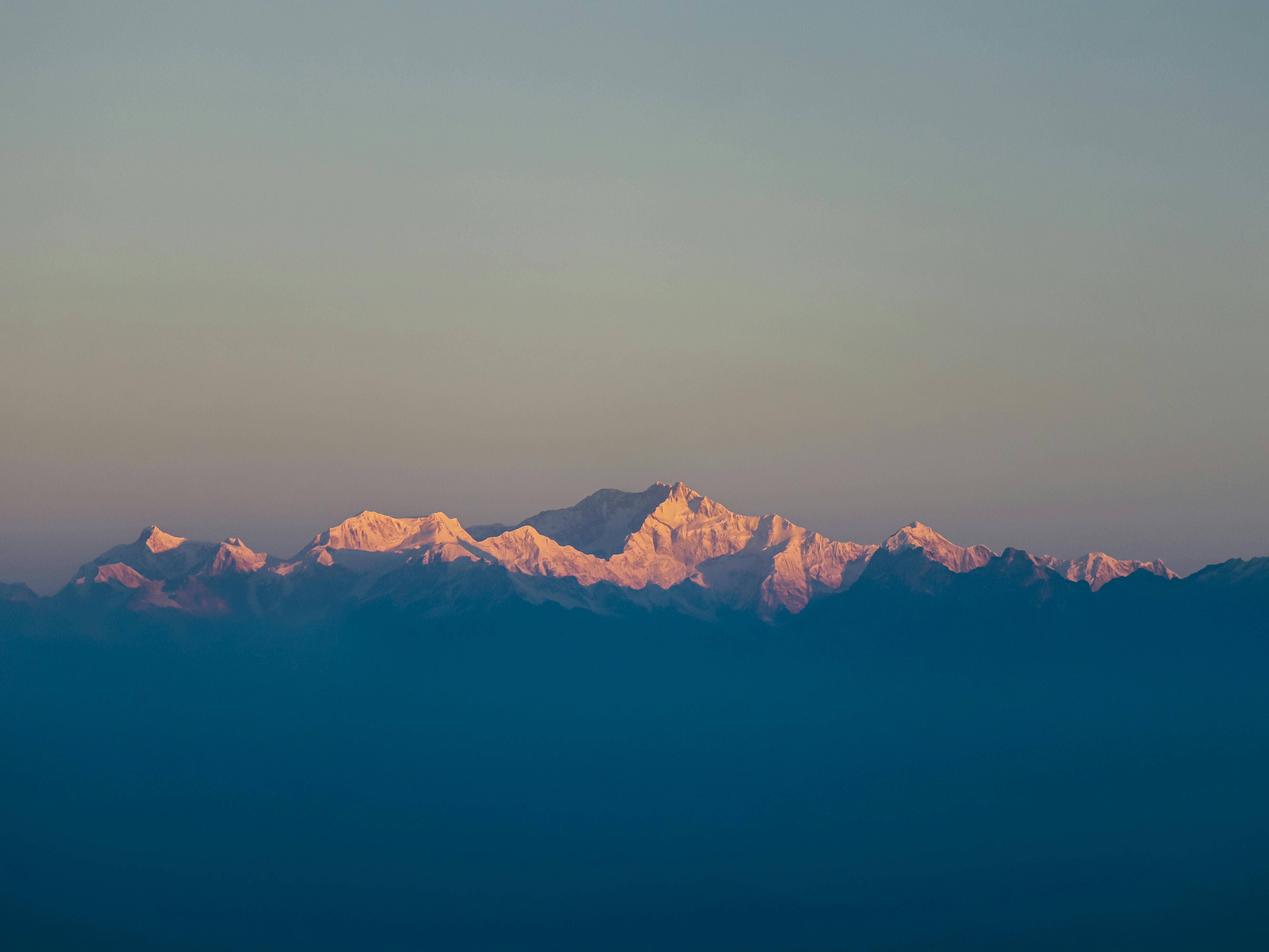 Stunning sunrise view of Kanchenjunga peak with vibrant colors in the Himalayan mountain range.