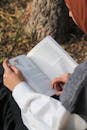 Woman reading book outdoors in quiet solitude