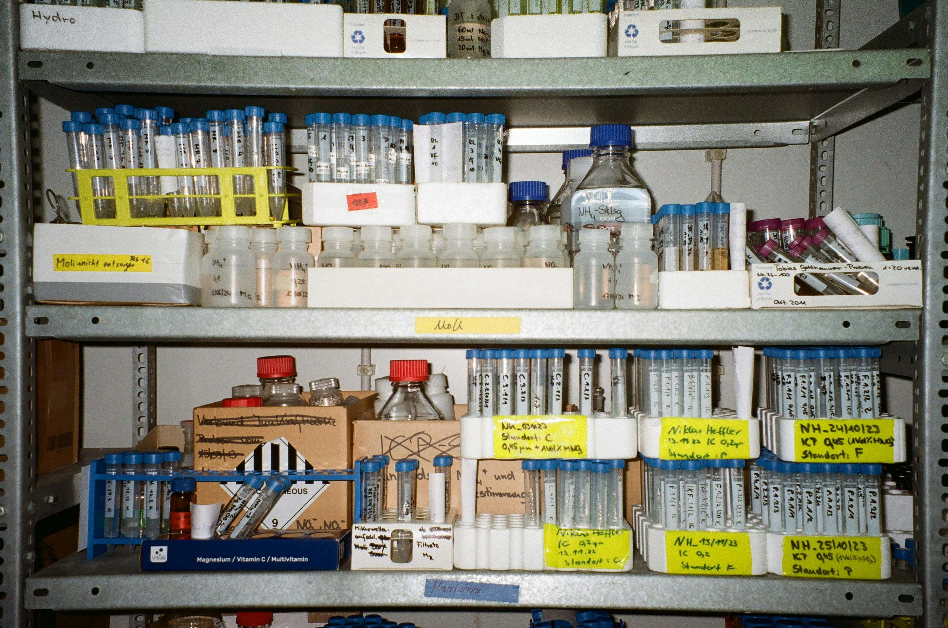 Laboratory shelves neatly arranged with vials and test tubes